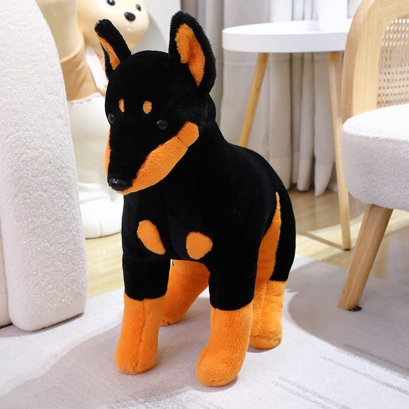 Peluche chien doberman noir et marron assis
