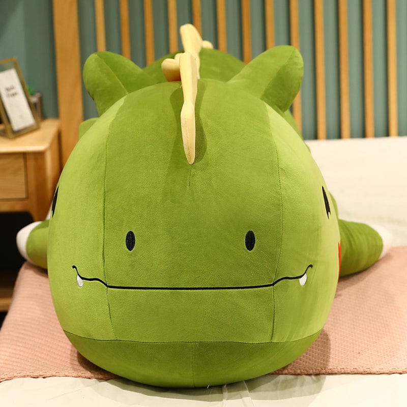 Peluche dinosaure avec un cœur sur la joue