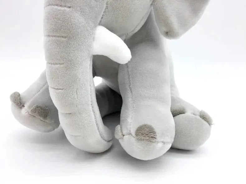 Peluche éléphant assis et content