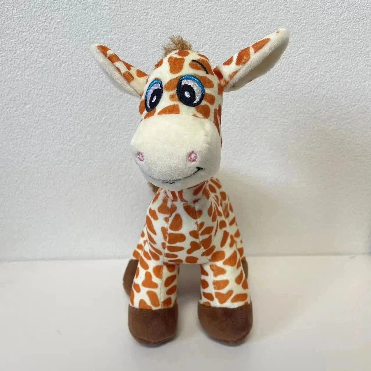 Peluche girafe aux gros yeux
