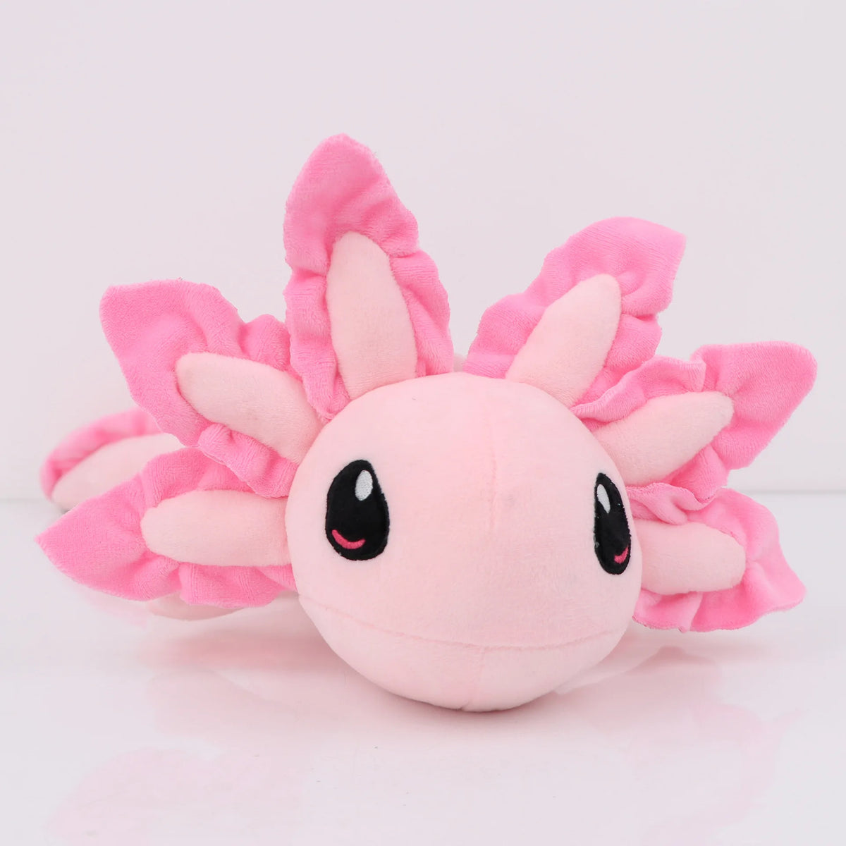 Peluche axolotl rose, à caler sous le bras comme un traversin