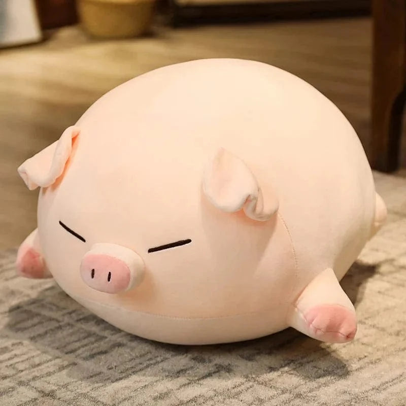 Peluche cochon allongé content