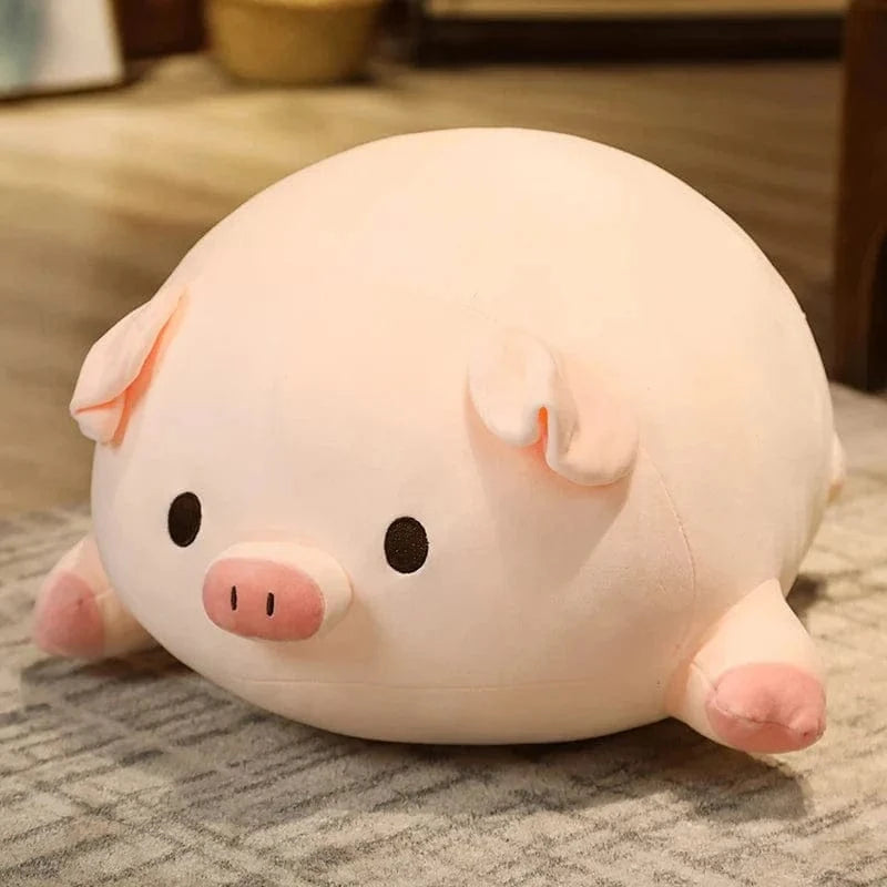 Peluche cochon allongé content
