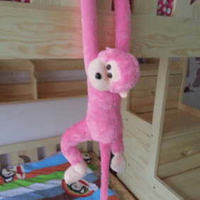 Peluche rose réaliste d'un singe amoureux de câlins