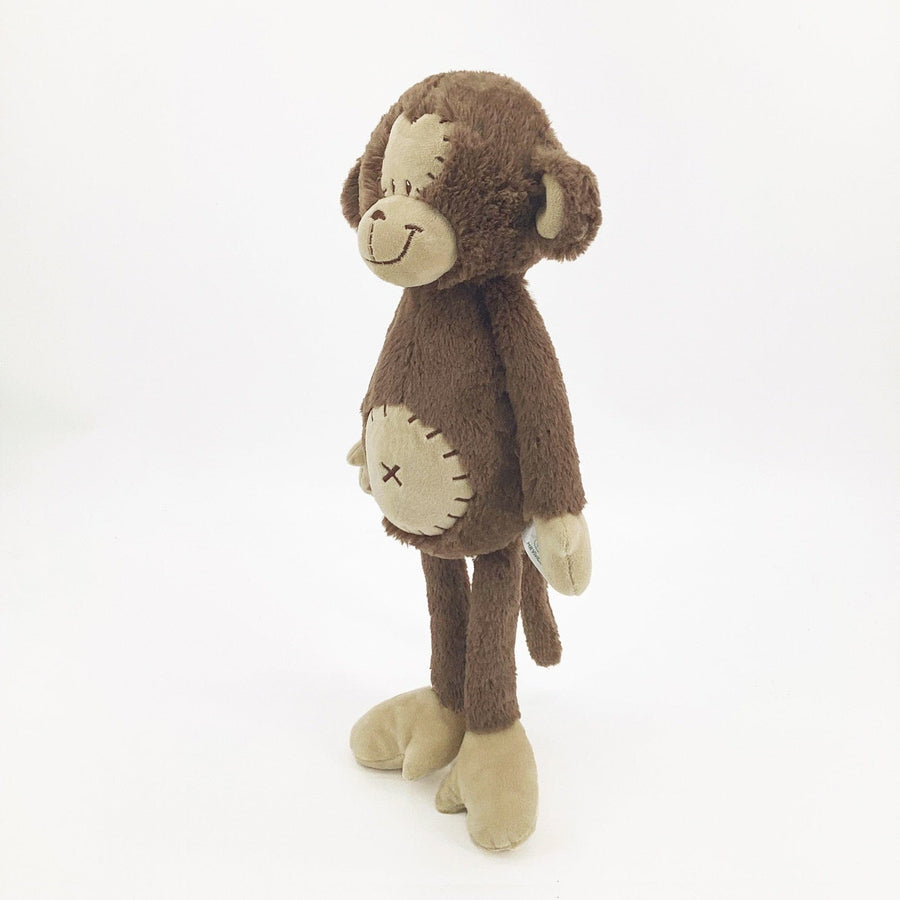 Peluche singe curieuse et attachante